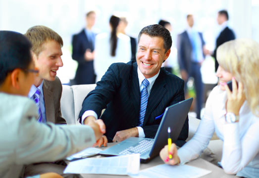 Business owners shaking hands in a meeting
