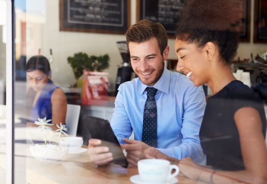 Two people finding a local business on a tablet
